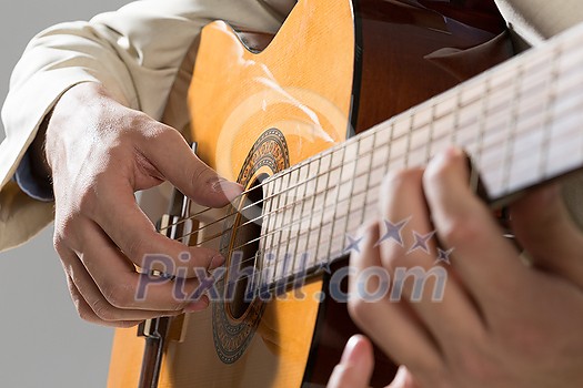 Close up of male hands playing acoustic guitar Close up of male hands playing acoustic guitar