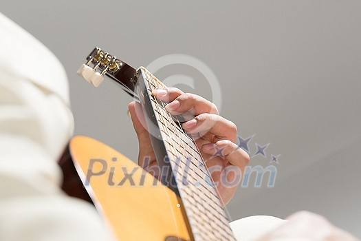 Close up of male hands playing acoustic guitar Close up of male hands playing acoustic guitar
