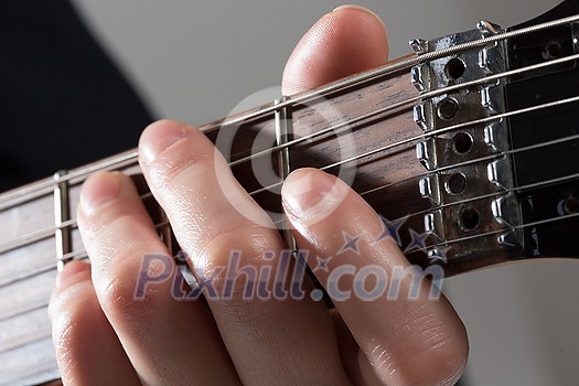 Close up of male hands playing electric guitar Close up of male hands playing electric guitar