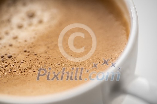 Closeup of tasty aromatic cup of coffee on white background, selective focus Closeup of tasty aromatic cup of coffee on white background, selective focus