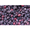 Closeup of frozen raspberries and blackberries in pile, top view