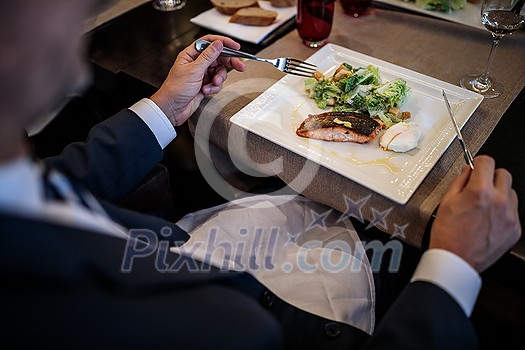 Fine dining experince in a gourmet restaurant - wild caught salmon being served Fine dining experince in a gourmet restaurant - wild caught salmon being served
