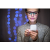 Young woman using her cell phone at home