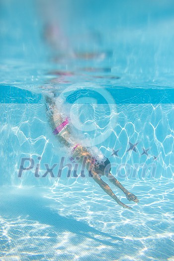 Young woman in a swimming pool enjoying days of summer Young woman in a swimming pool enjoying days of summer