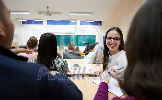 portrait of a beautiful girl sitting in an amphitheater and talking to her colleagues while attending classes portrait of a beautiful girl sitting in an amphitheater and talking to her colleagues while attending classes