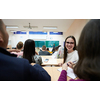 portrait of a beautiful girl sitting in an amphitheater and talking to her colleagues while attending classes