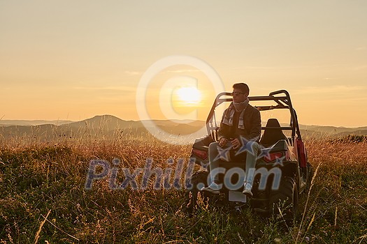 portrait of young happy excited man enjoying beautiful sunny day while driving a off road buggy car on mountain nature