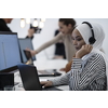 beautiful modern african Muslim businesswoman in office, wearing hijab speaking on headset at modern startup coworking space