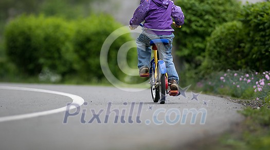 Little cyclist on a little bike (shallow DOF) Little cyclist on a little bike (shallow DOF)