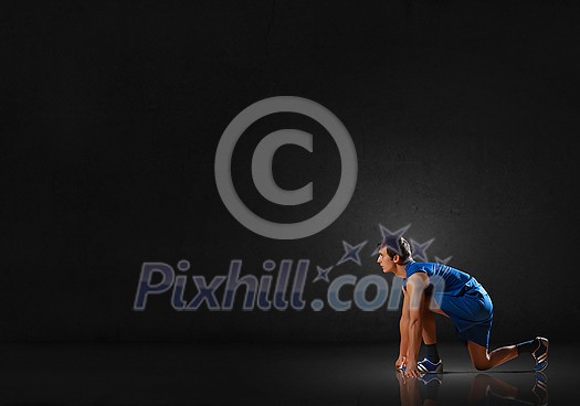 Young man athlete standing in start pose