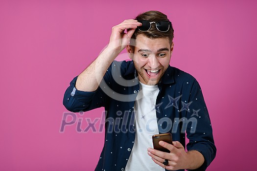 a portrait of a young man wearing a blue shirt and sunglasses using a smartphone with different facial expressions
