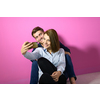 a happy young couple sitting on the floor in the house and making selfie for social network
