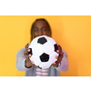 an afro man posing on a yellow background while holding a soccer ball in his hand
