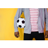 an afro man posing on a yellow background while holding a soccer ball in his hand
