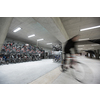 Motion blurred people - figures in an underpassage getting to their workplace in the morning. Busy city business life.