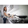 Pretty, young woman washing dishes in a modern kitchen (shallow DOF; color toned image)