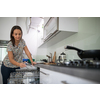 Pretty, young woman putting dishes in the dishwasher (shallow DOF; color toned image)