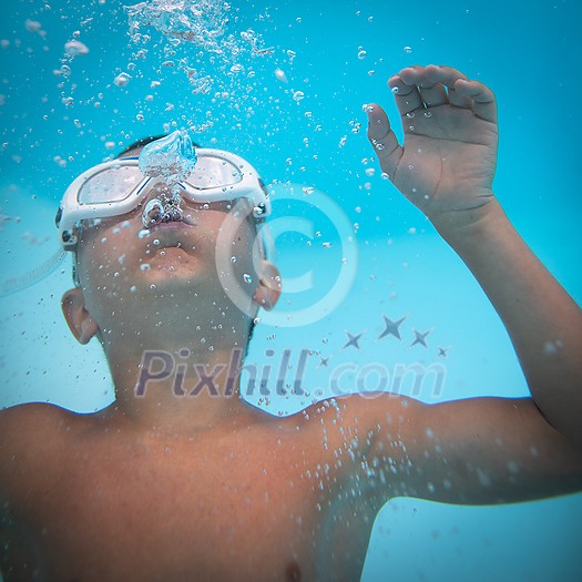 Cute little boy in a swimming pool