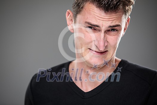 Fear/anxiety/regret/uncertainty in a young man - effects of a difficult life situation - vivid emotions concept Fear/anxiety/regret/uncertainty in a young man - effects of a difficult life situation - vivid emotions concept
