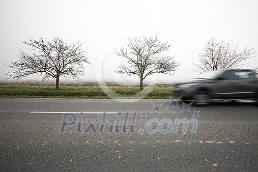 Motion blurred truck going fast on a rural road Motion blurred truck going fast on a rural road