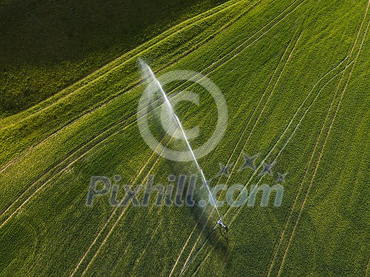 Farmland from above - aerial image of a lush green field being irrigated Farmland from above - aerial image of a lush green field being irrigated