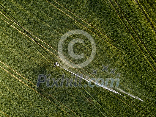 Farmland from above - aerial image of a lush green field being irrigated Farmland from above - aerial image of a lush green field being irrigated