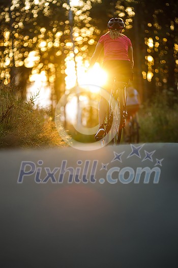 Happy couple riding bicycles outside, healthy lifestyle fun concept, taking a break admiring the view Happy couple riding bicycles outside, healthy lifestyle fun concept, taking a break admiring the view