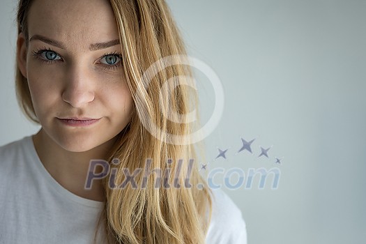 Pretty, young woman looking at the camera - pensive, pondering