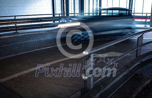 Underground parking. Cars parked in a garage with no people. Many cars in parking garage interior. Underground parking with cars (color toned image) Underground parking. Cars parked in a garage with no people. Many cars in parking garage interior. Underground parking with cars (color toned image)