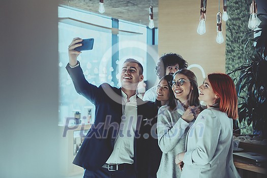 Business people taking selfies in the office. The business team taking a selfie together at startup