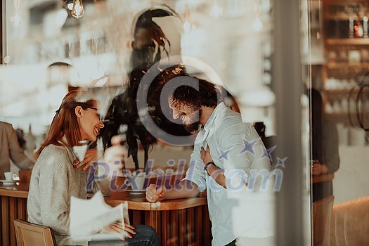 a woman in glasses and men with afro hair sit in a cafe and talk about business projects