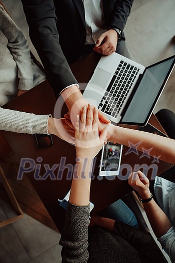 young business people putting their hands together. Stack of hands. Unity and teamwork concept. young business people putting their hands together. Stack of hands. Unity and teamwork concept.
