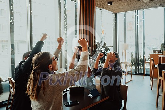 group of businessmen with their hands up celebrate successful business