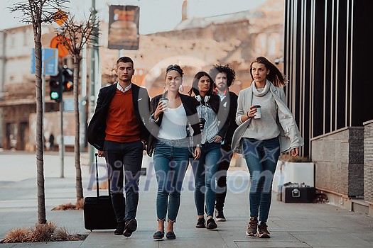 Happy business people walking in the street after a successful day of work and discussing the closed deals. High-quality photo Happy business people walking in the street after a successful day of work and discussing the closed deals. High-quality photo
