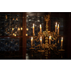 Splendid chandelier with lit candles in a beautiful room of an old mansion