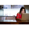 Pretty, mid-aged woman having a virtual Wine Tasting Dinner Event Online Using Laptop with friends