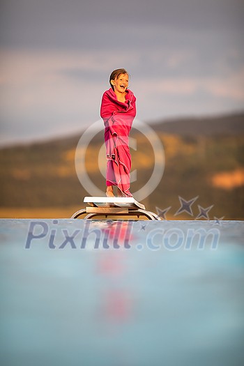 Little girl on a pool's edge, learning to swim and dive. Swimming with kids. Healthy sport activity for children. Sun protection. Water fun. Little girl on a pool's edge, learning to swim and dive. Swimming with kids. Healthy sport activity for children. Sun protection. Water fun.