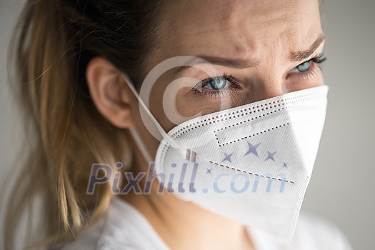 Young woman wearing a face mask during coronavirus and flu outbreak. Virus and illness protection, home quarantine. COVID-19 concept Young woman wearing a face mask during coronavirus and flu outbreak. Virus and illness protection, home quarantine. COVID-19 concept