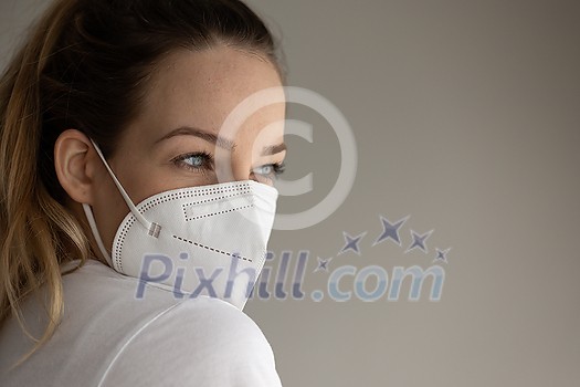 Young woman wearing a face mask during coronavirus and flu outbreak. Virus and illness protection, home quarantine. COVID-19 concept Young woman wearing a face mask during coronavirus and flu outbreak. Virus and illness protection, home quarantine. COVID-19 concept