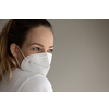 Young woman wearing a face mask during coronavirus and flu outbreak. Virus and illness protection, home quarantine. COVID-19 concept