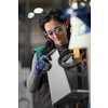 Woman worker wearing safety goggles control lathe machines to drill components. Metal lathe industrial manufacturing factory. High quality photo
