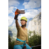 Pretty, female climber on a via ferrata - climbing on a rock in Swiss Alps