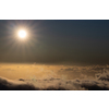 Sky above clouds with sun shining intensely - Earth's atmosphere concept