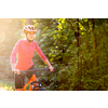 Pretty, young woman biking on a mountain bike enjoying healthy active lifestyle outdoors in summer (shallow DOF)