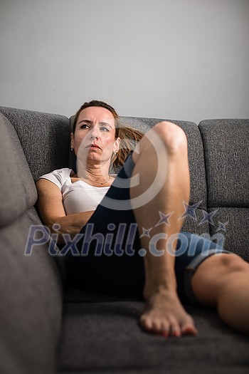 Depressed mid-aged woman at home feeling sad, lonely, anxious (color toned image) Depressed mid-aged woman at home feeling sad, lonely, anxious (color toned image)