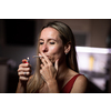 Mid-aged woman lighting a cigarette at home, getting her nicotine daily dose