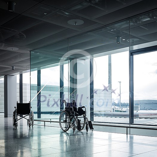 Wheelchairs in a modern airport. Wheelchairs ready for use by passangers with disabilities