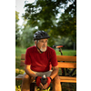 Senior man with his mountain bike going for a ride past the city limits in a lovely forest, getting the daily cardio dose, having a break on a bench