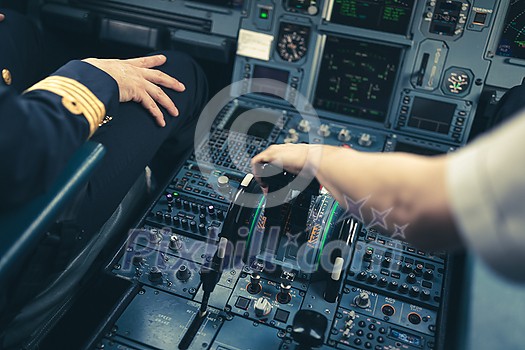 Pilot's hand accelerating on the throttle in a commercial airliner airplane flight cockpit during takeoff Pilot's hand accelerating on the throttle in a commercial airliner airplane flight cockpit during takeoff