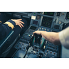 Pilot's hand accelerating on the throttle in  a commercial airliner airplane flight cockpit during takeoff